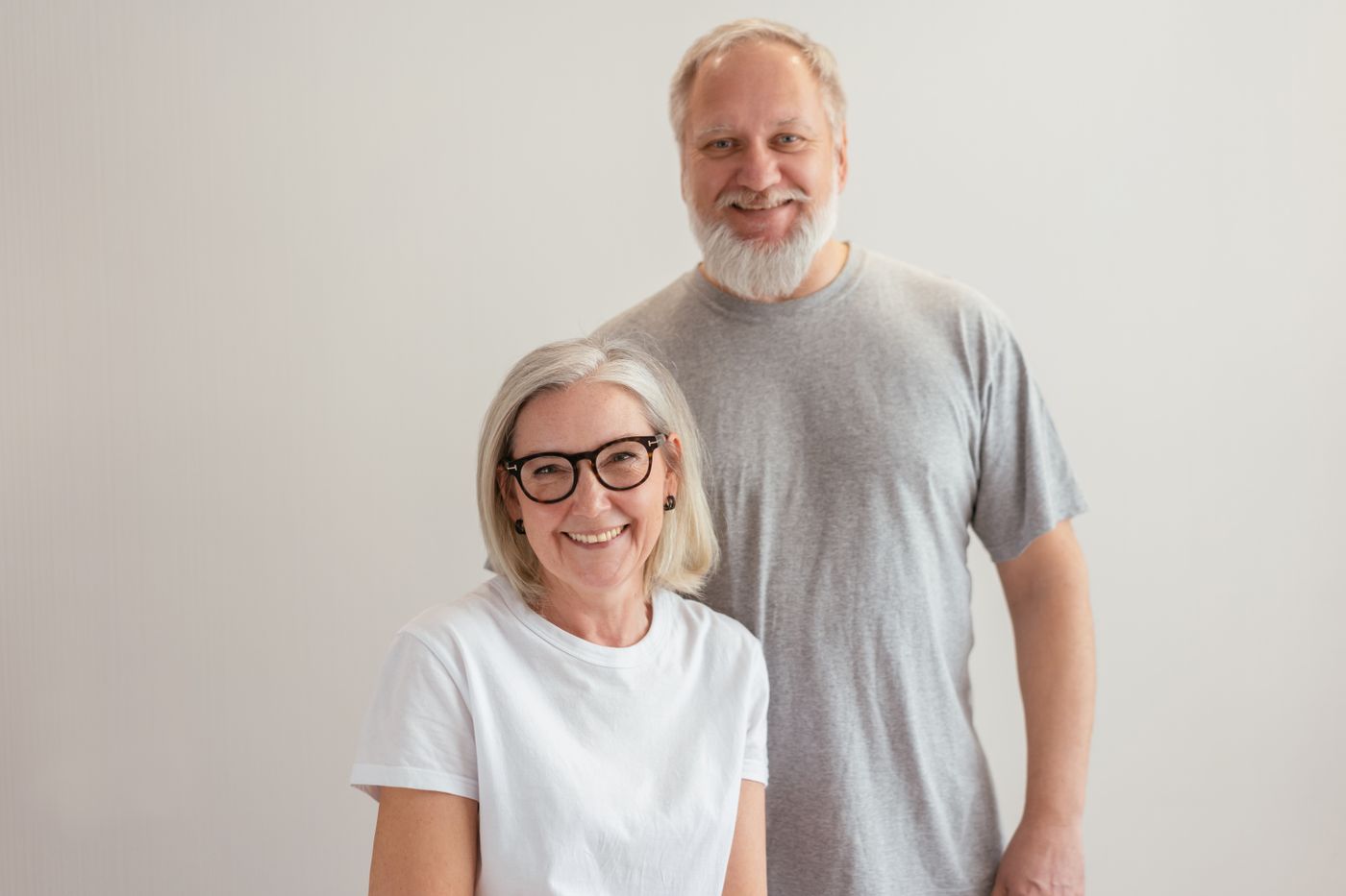 A smiling older couple looking at the camera